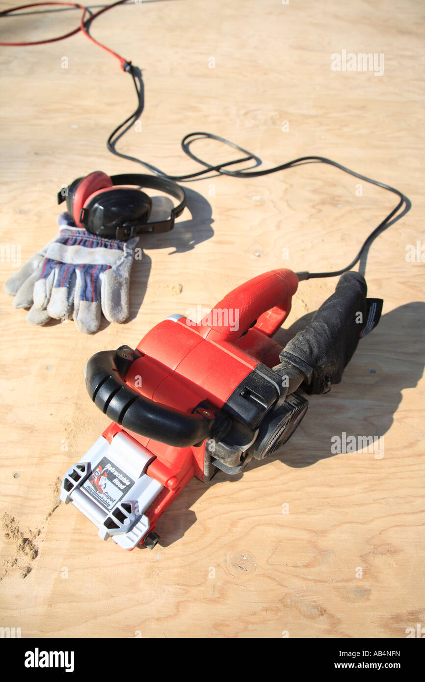 Home renovation concept belt sander with work gloves Stock Photo Alamy