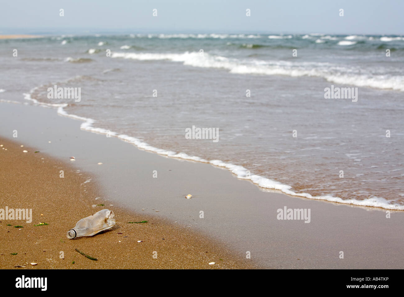 Plastic bottle washed up on beach Stock Photo - Alamy