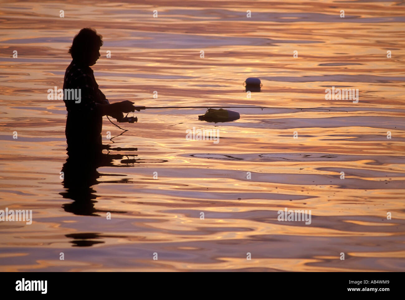 Fisherman at sunset on Lake Superior at Copper Harbor Upper Peninsula Michigan MI Stock Photo