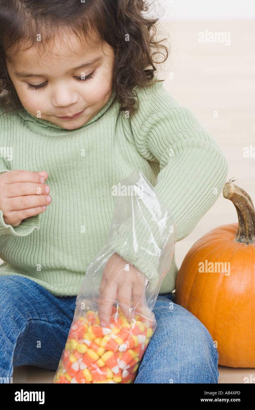 Little girl eating candy corn Stock Photo Alamy