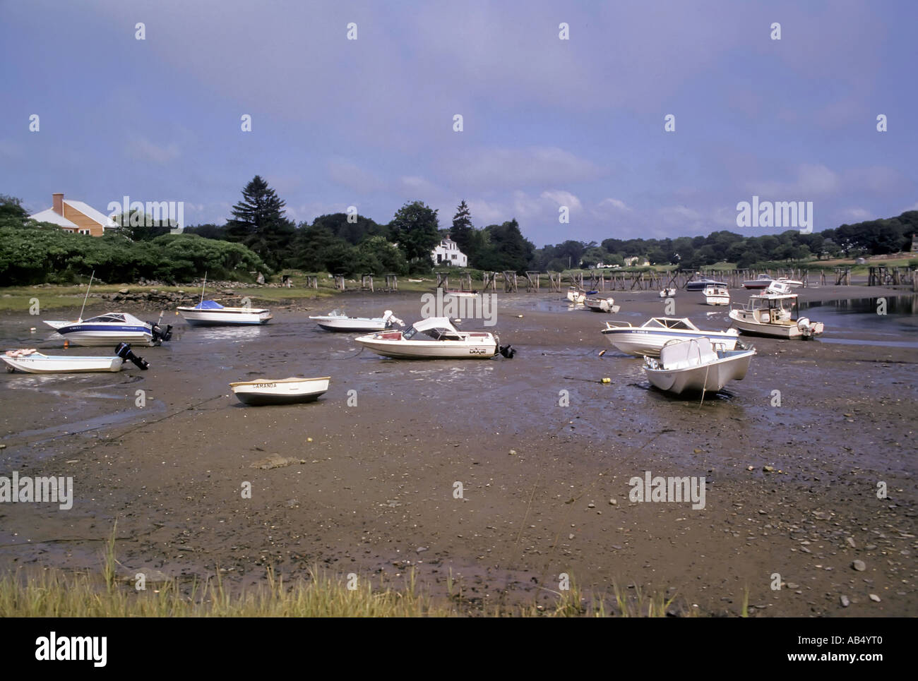 Boats rest on ground at low tide in a small harbor in Ogunquit Maine ME Stock Photo