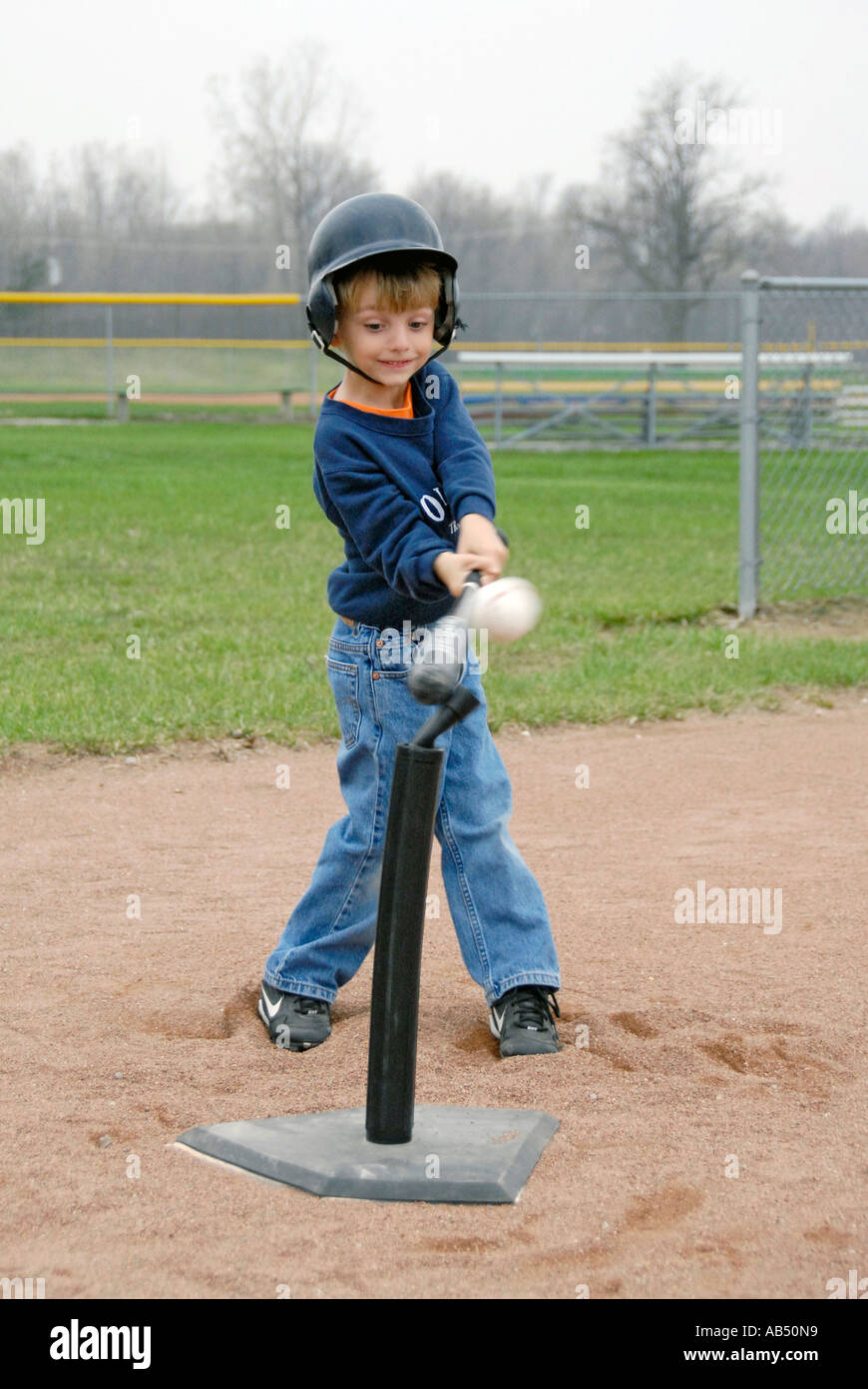 5 year old boys and girls learn how to play baseball by participating in a T ball league for tots Stock Photo