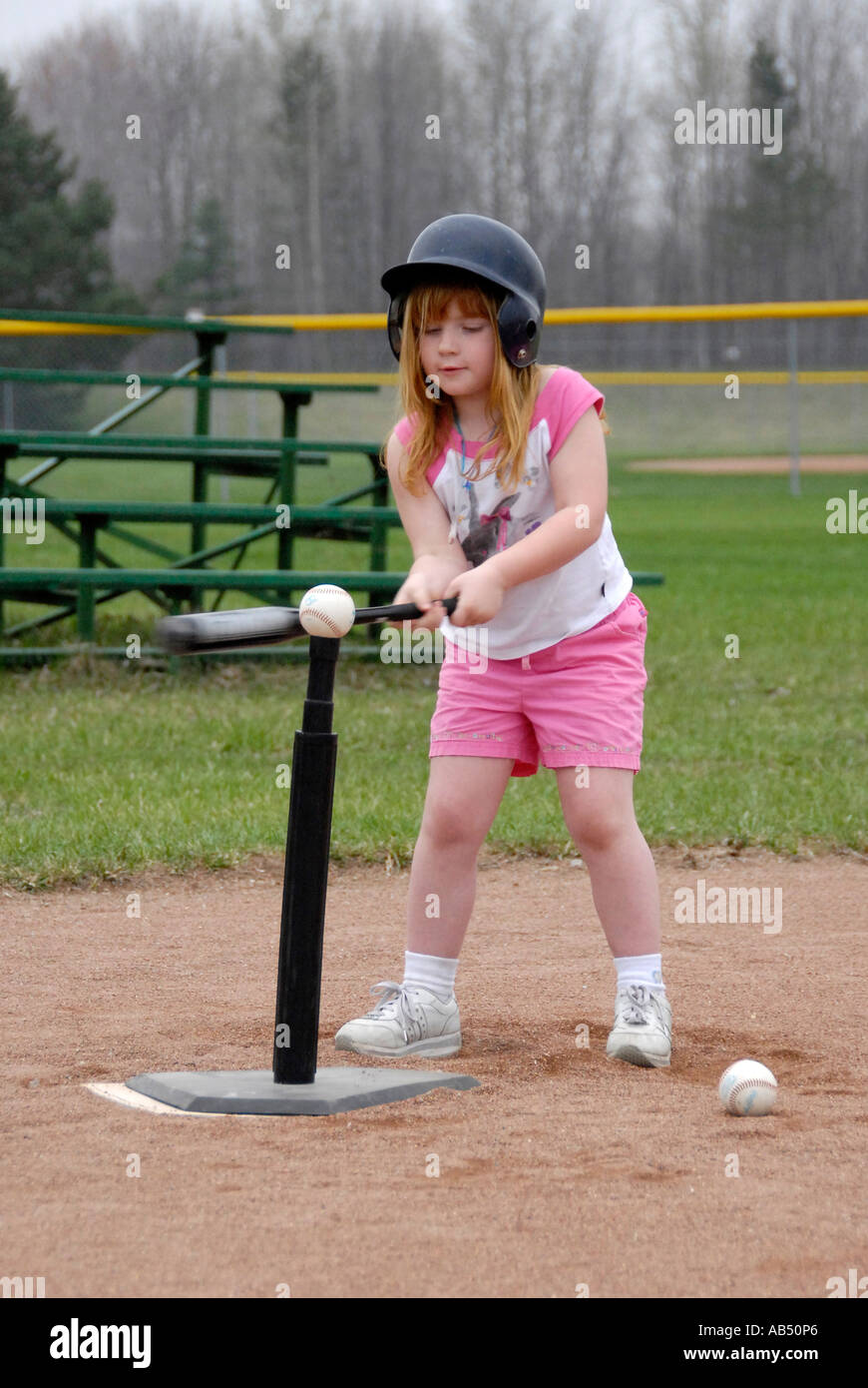 5 year old boys and girls learn how to play baseball by participating in a T ball league for tots Stock Photo