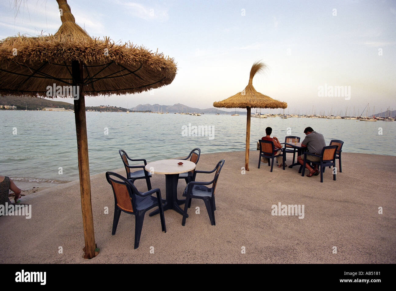 Seafront tables and umbrellas in Puerto Pollensa in Majorca Stock Photo
