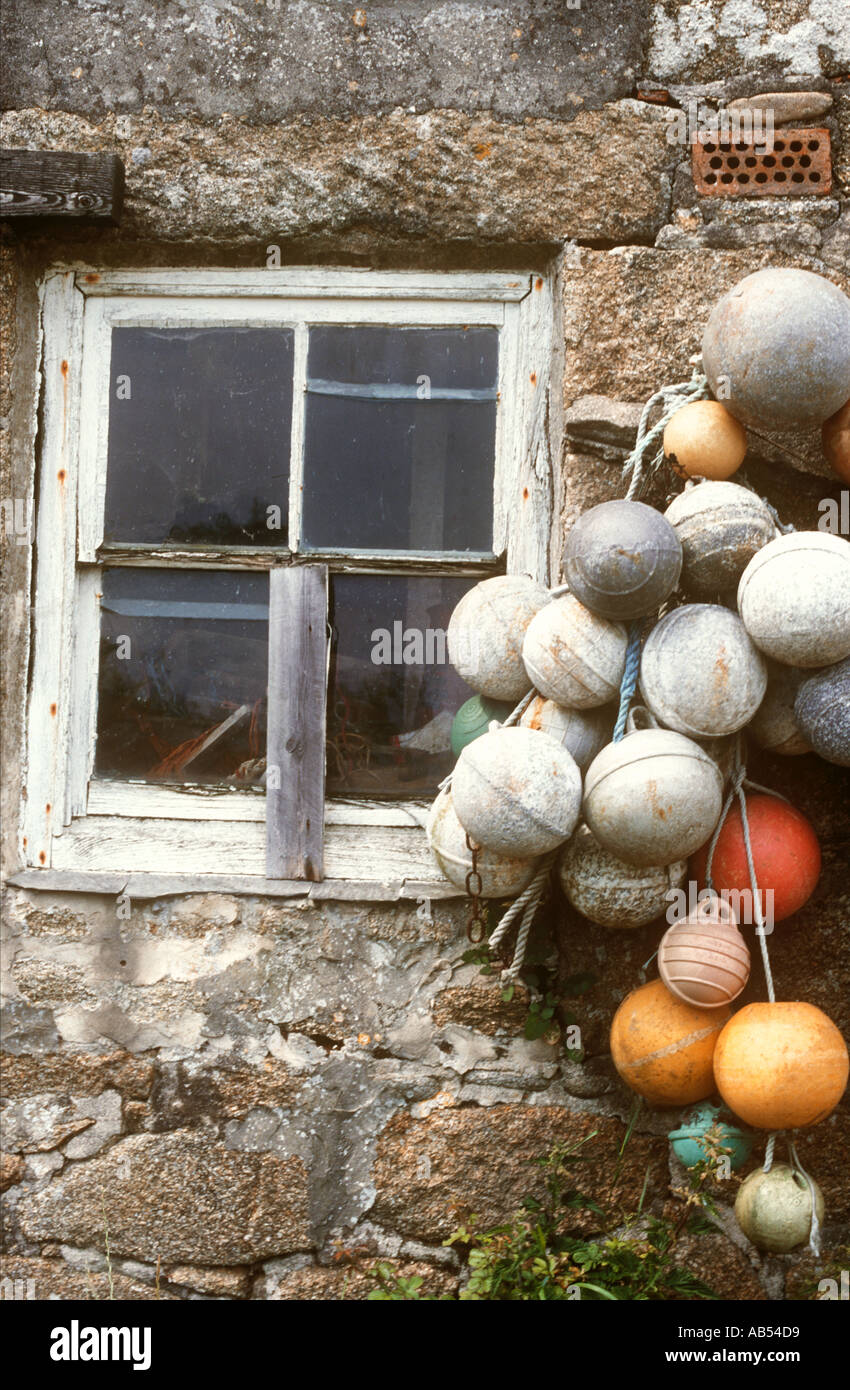Detail of old fishing buoys decorating a stone building on the island of St Martins Isles of Scilly, Cornwall, UK Stock Photo