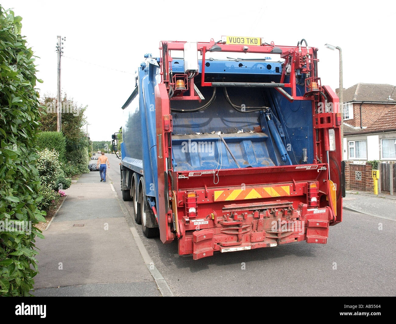 Local authority waste management rubbish truck on household street