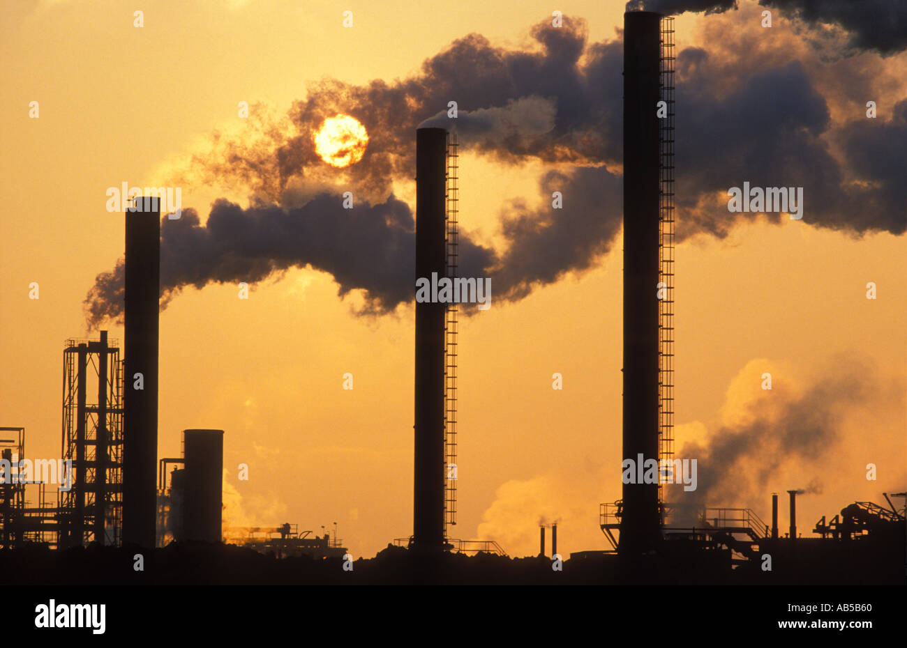 Belching smokestacks Pollution at sunset Avonmouth Avon England UK Stock Photo