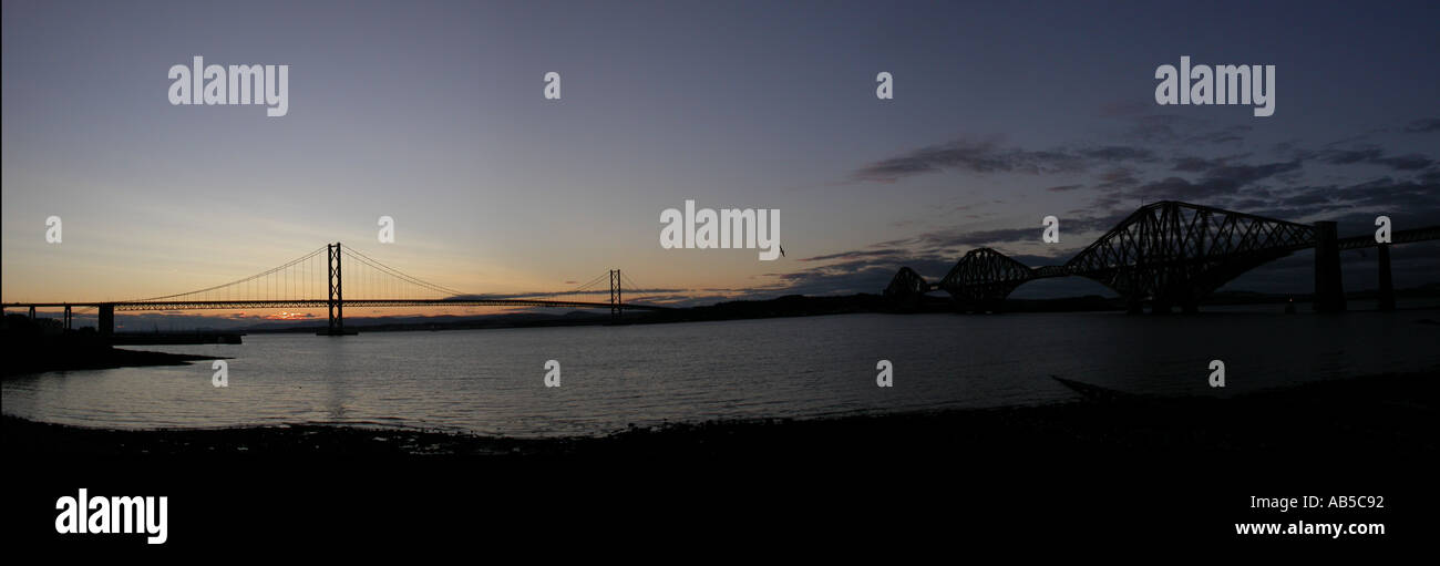 Panoramic sunset view of the Forth road and rail bridges from South Queesferry Stock Photo
