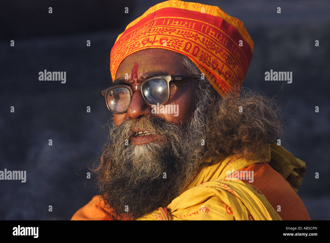 A 'Sadhu', a holy man in Hindu belief, sitting in the sunset Stock Photo