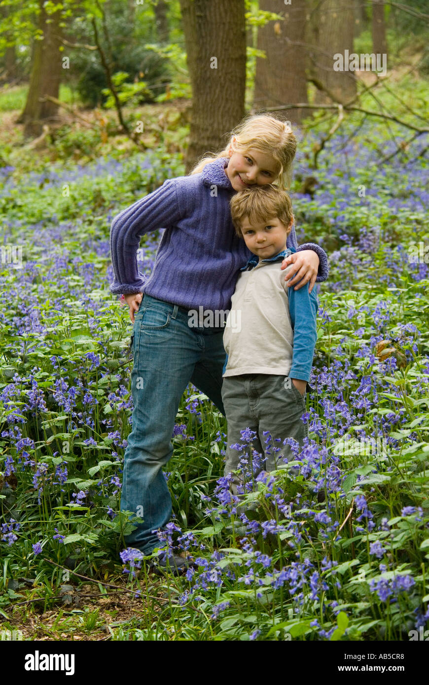 Borther and sister playing in the bluebell woods Stock Photo - Alamy