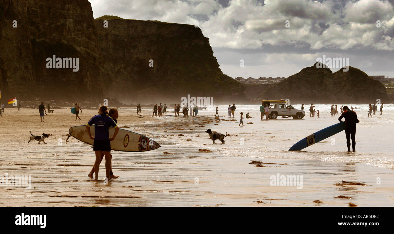 surfers in Watergate beach near Newquay a popular destination for