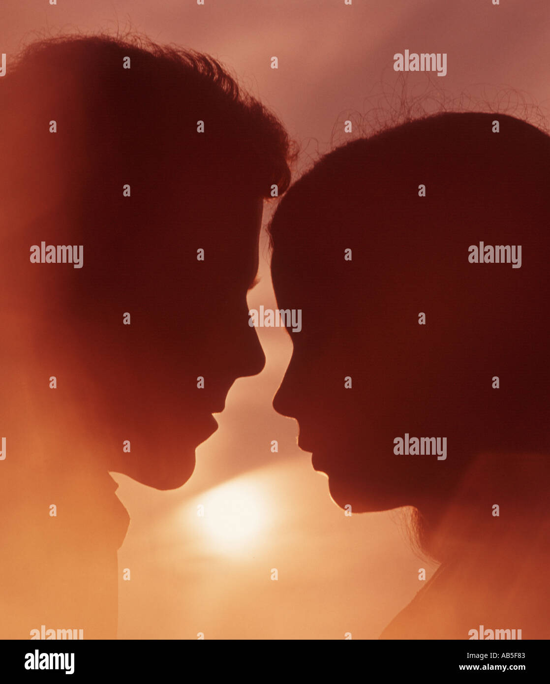 romantic couple embracing at sunset Stock Photo