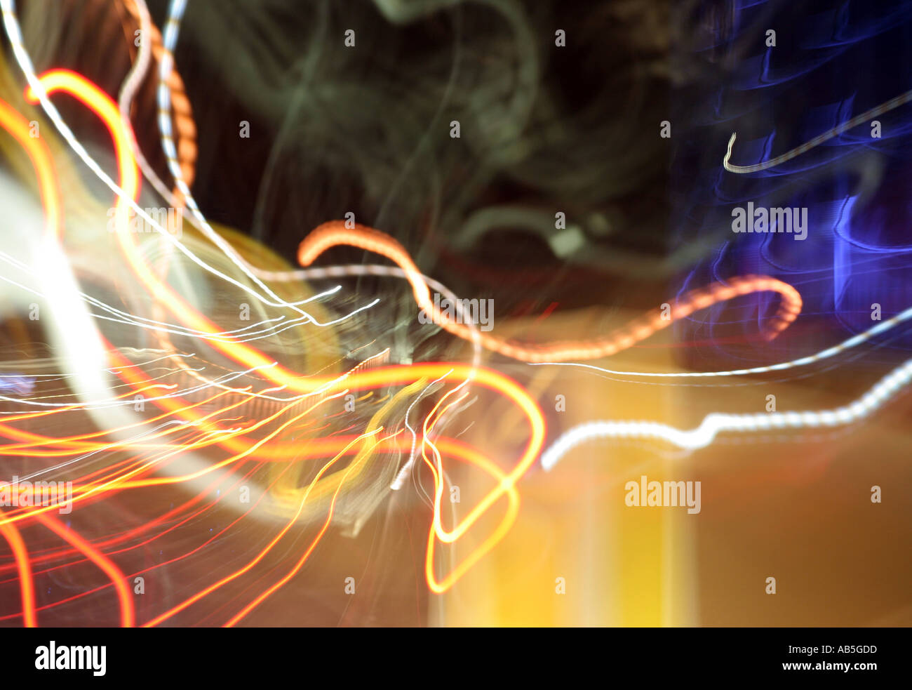 wavy lights of car traffic flying past a traffic beacon near the bfi s