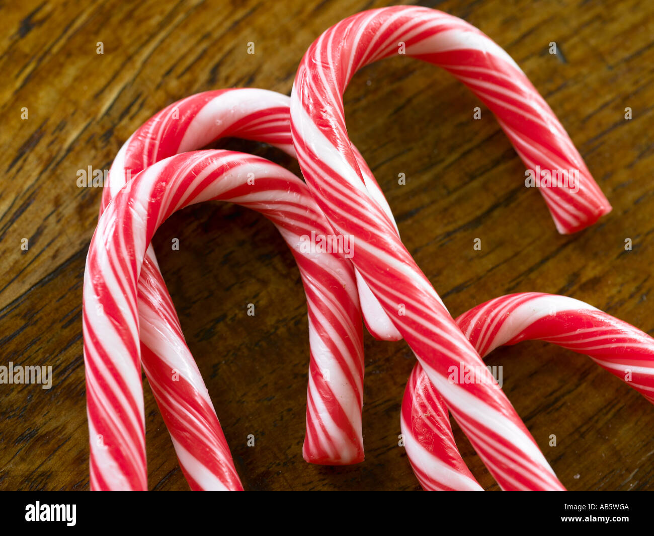 four red and white candy cane layered down crossing each other on top ...