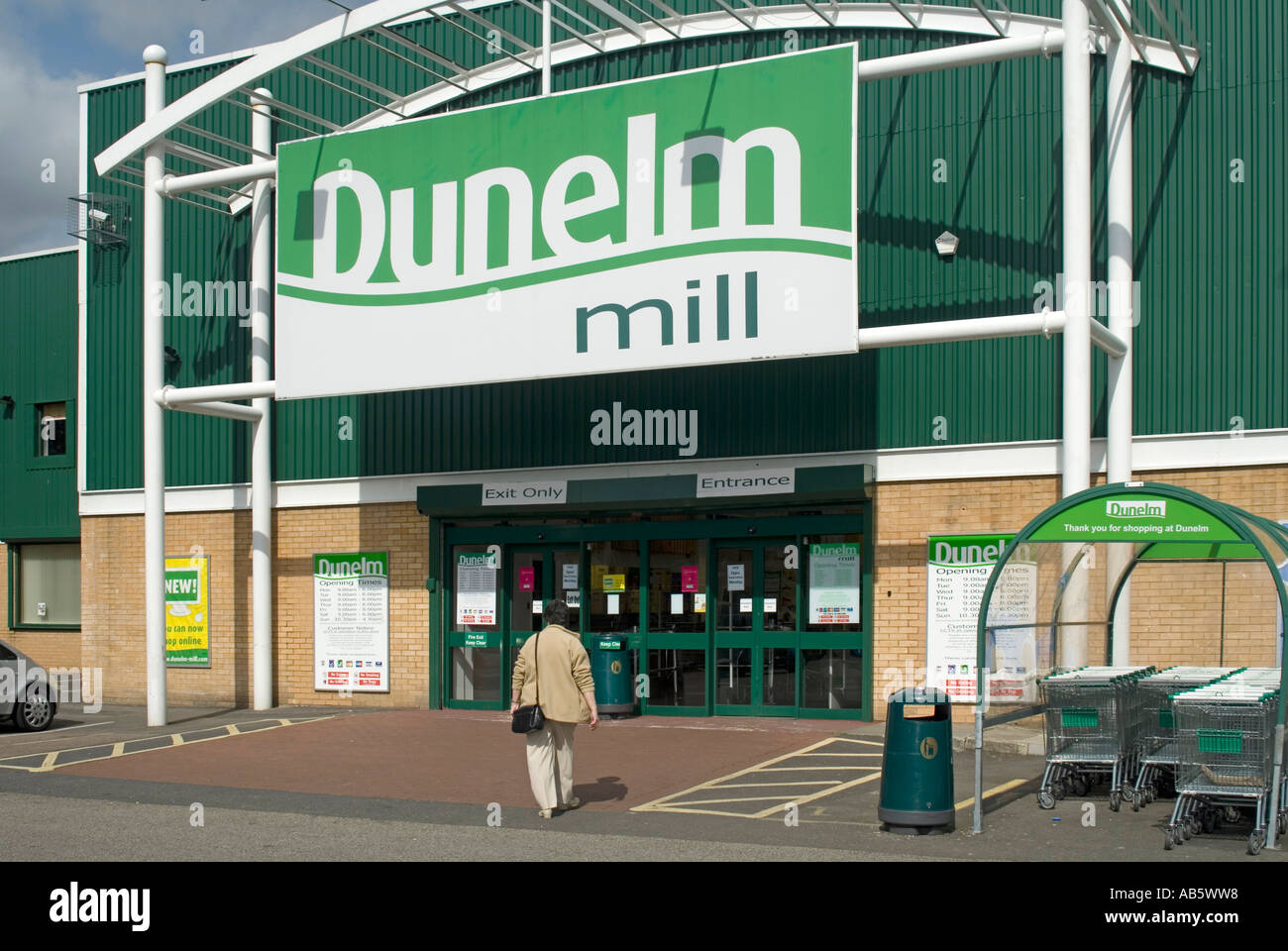 Model released shopper walking towards Romford Dunelm Mill home furnishings retail store main entrance Stock Photo