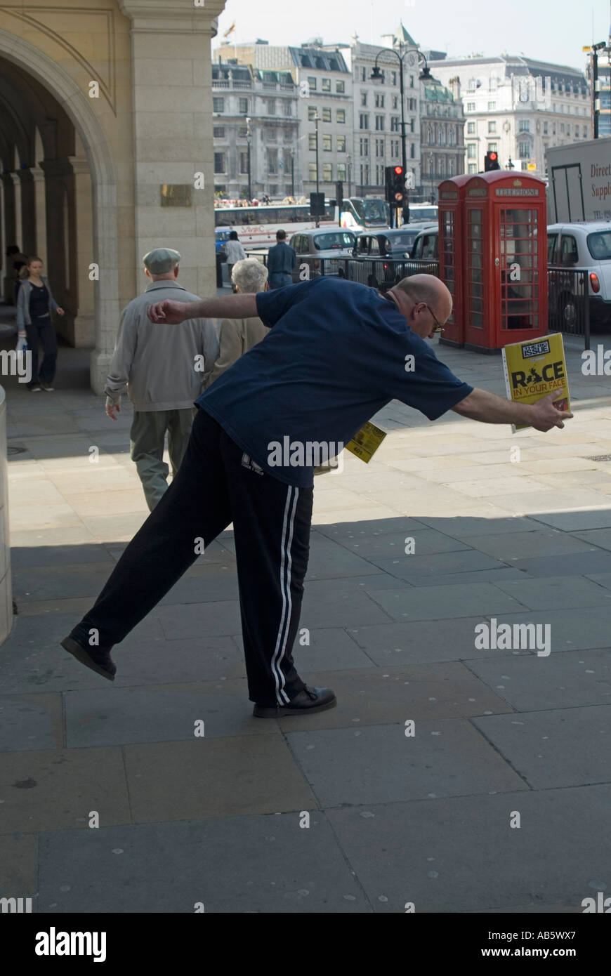 Trafalgar Square Big Issue magazine seller doing a pose to attract attention Stock Photo