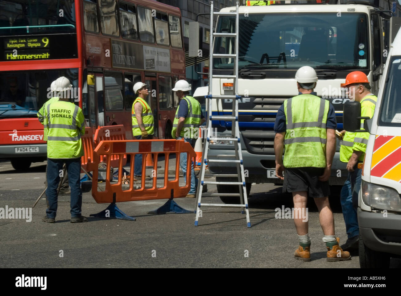 Workmen standing around not working waiting around traffic lights in