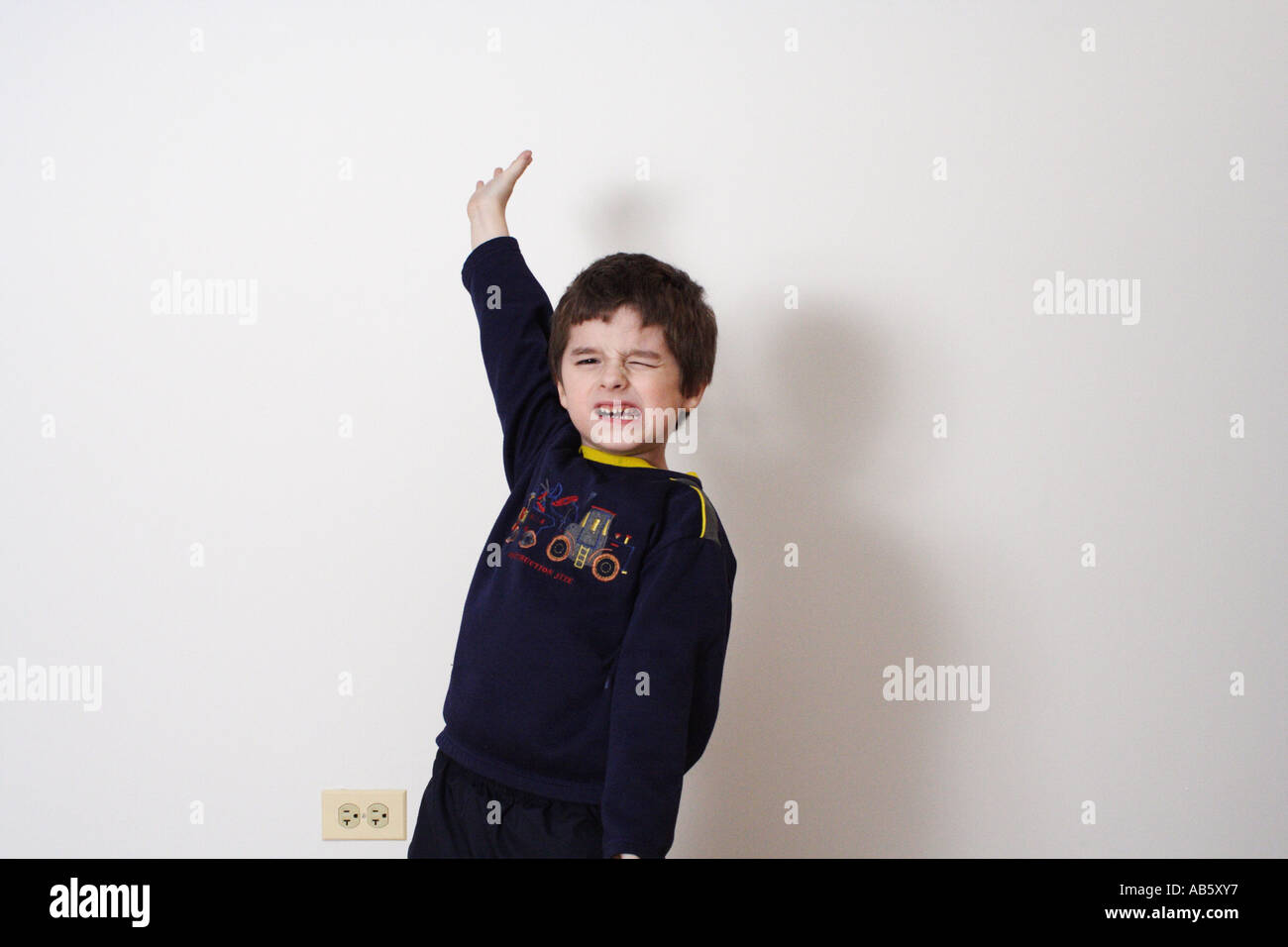 Boy is making faces while posing for the camera. Stock Photo