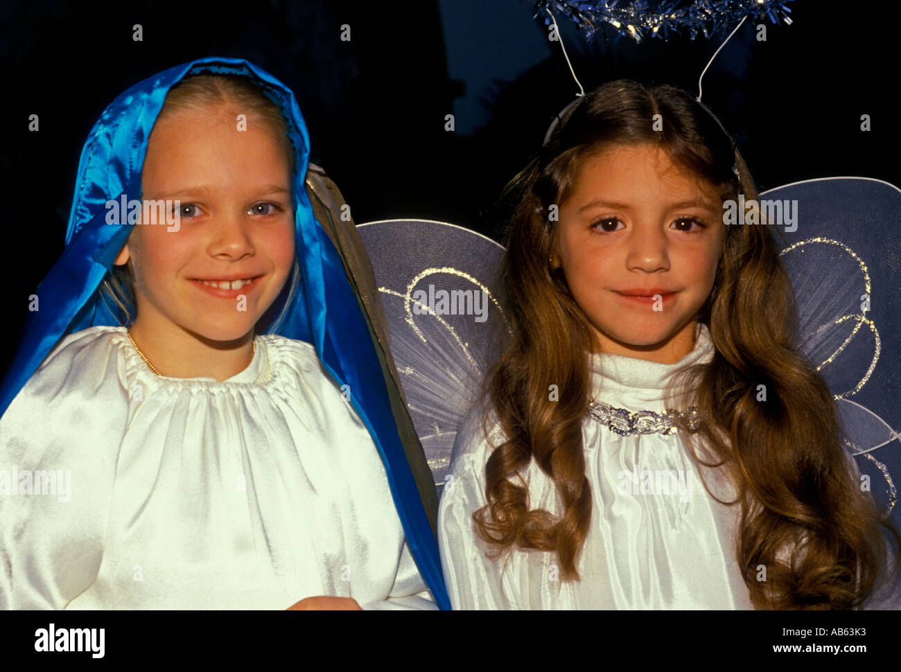 2, two, girls, actors, Virgin Mary, on left, Angel of the Lord, on right, eye contact, front view, portrait, Las Posadas, San Antonio, Texas Stock Photo