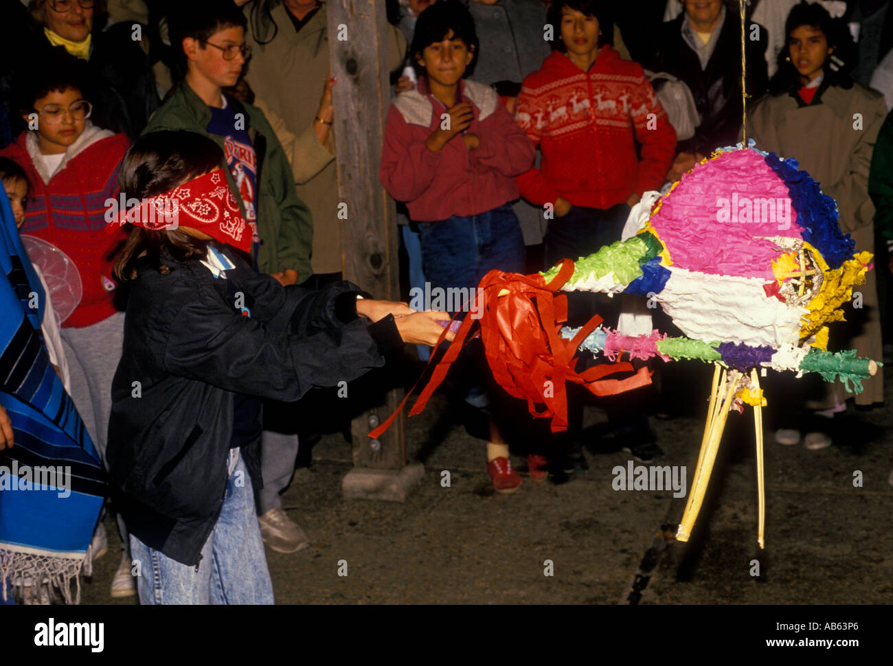 Mexican-American, girl, breaking pinata, Las Posadas, Christmas celebration, Paseo del Rio, riverwalk, San Antonio, Texas, United States Stock Photo