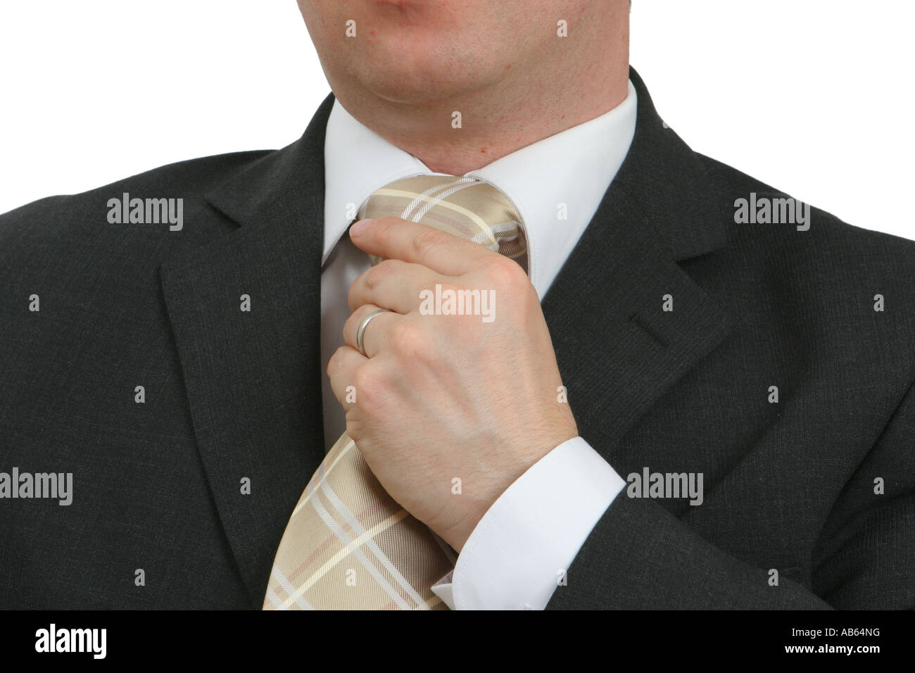 Businessman in suit adjusting tie Stock Photo