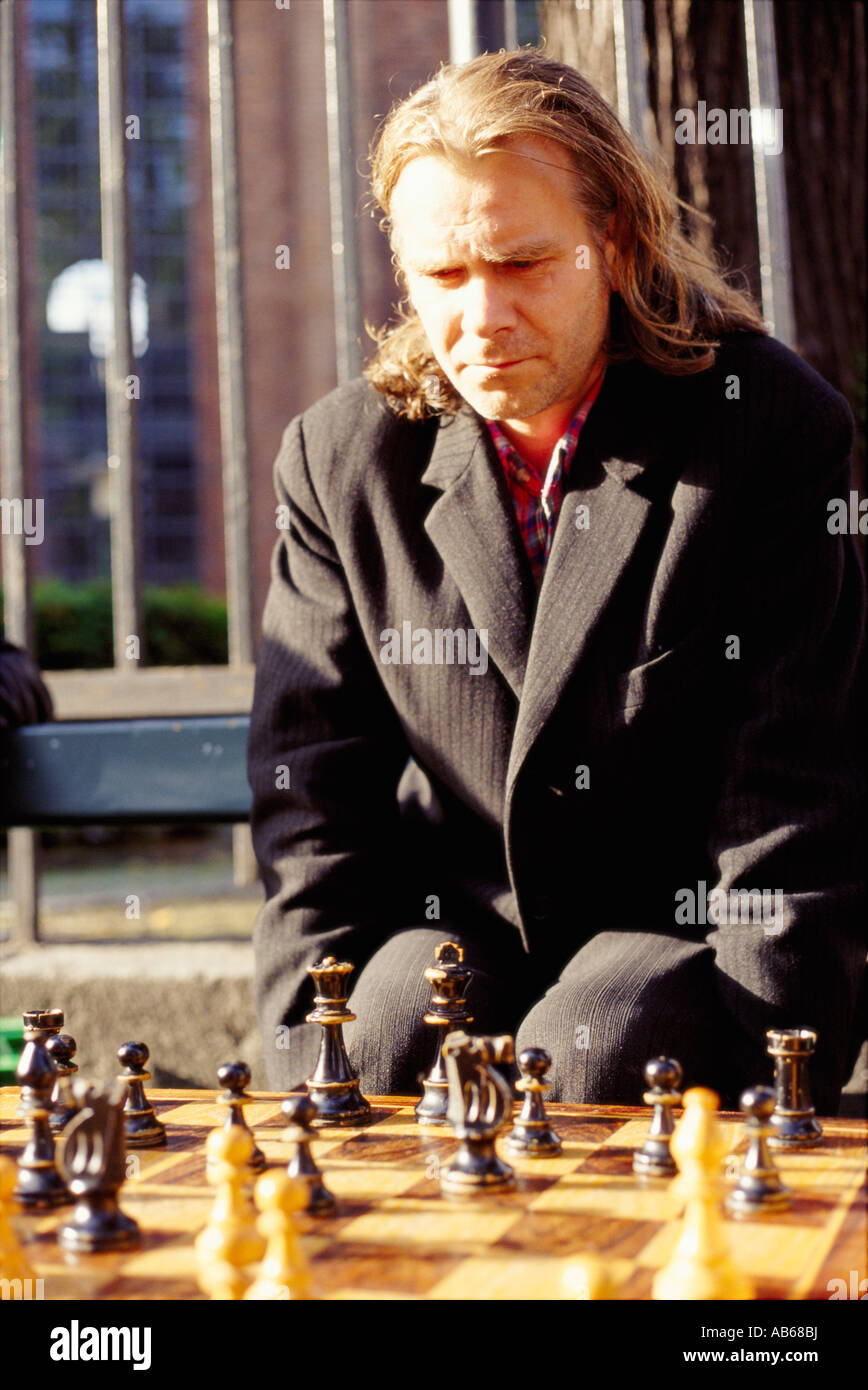 A young chess player contemplates a game plan or strategic