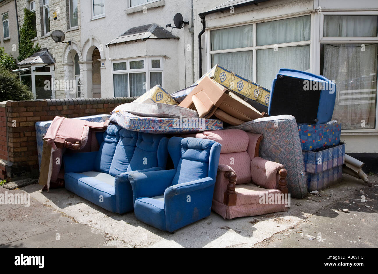 Furniture from house clearance left outdoors on street corner Cardiff Wales UK Stock Photo