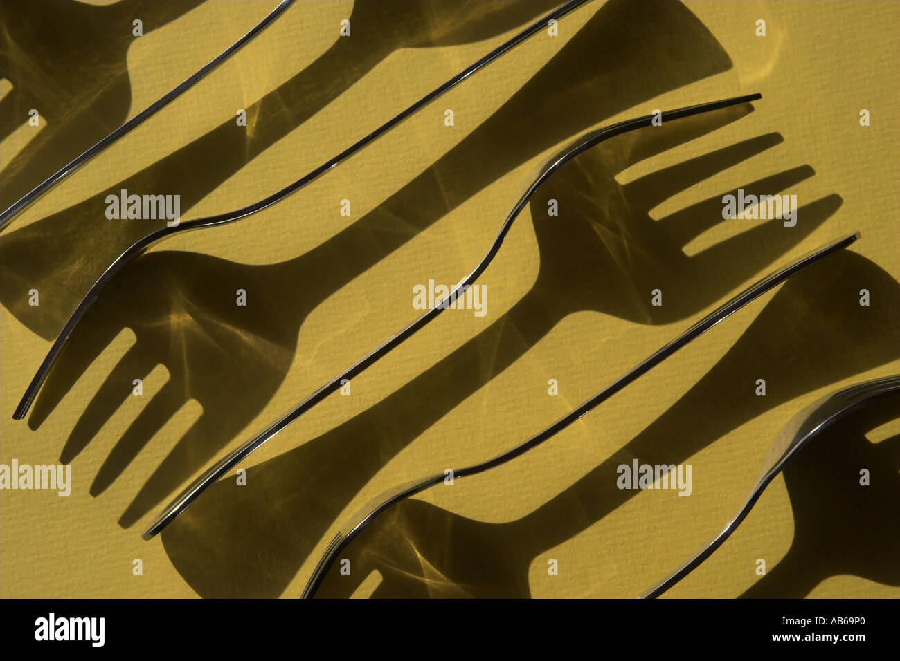 Fork shadows cast onto coloured cardboard stock photo alamy