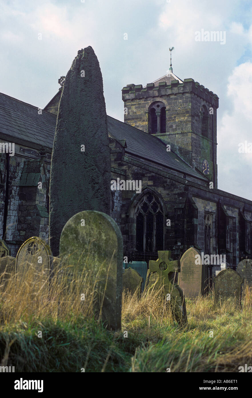 The tallest standing stone in Britain rises 25 feet 4 inches from the churchyard of All Saints Church Rudston in East Yorkshire Stock Photo