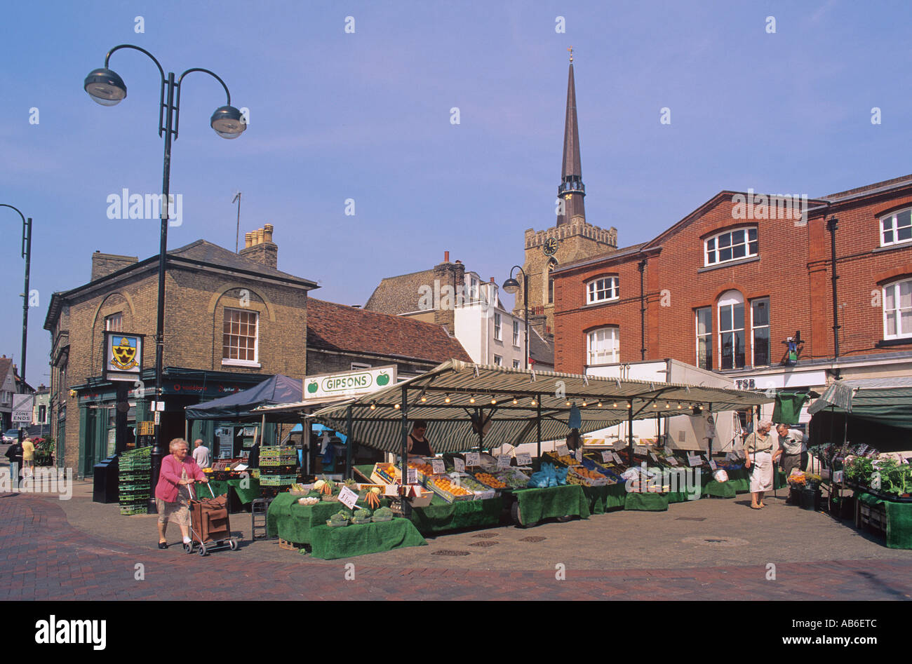 Farmers market in the centre of Stowmarket overlooked by the spire of SS Peter and Paul Suffolk Stock Photo