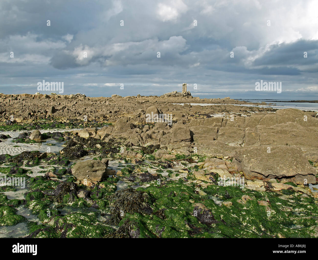 low tide stony strand with granit rocks at the coast near by Kerlouan ...