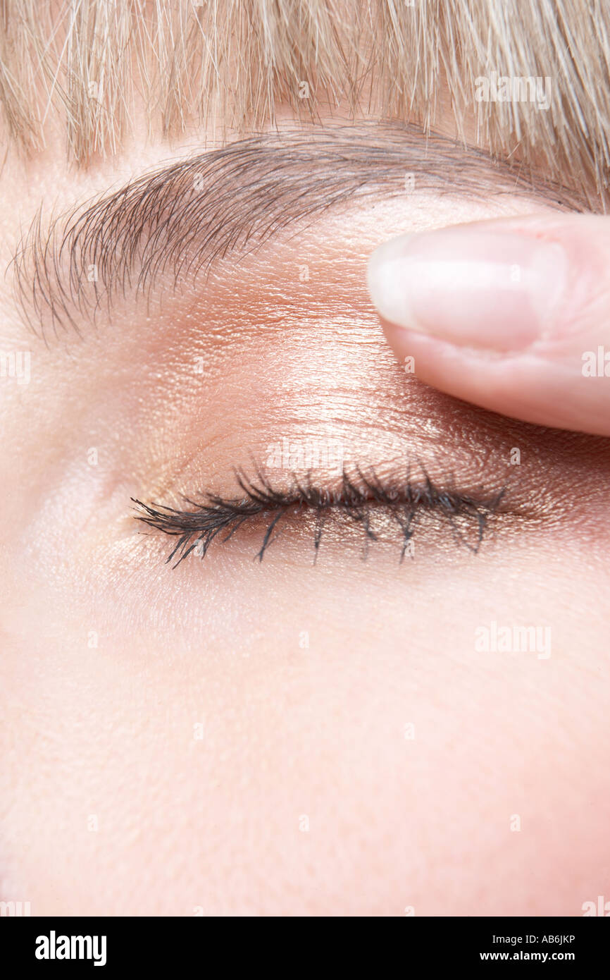 Eye close-up with finger Stock Photo - Alamy
