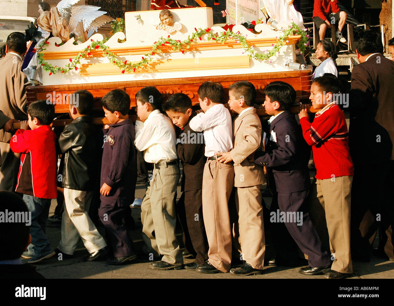 Young boys carrying a symbolic coffin as part of Lent  celebrations in Quetzaltenango, ( Xela ), Guatemala. Stock Photo