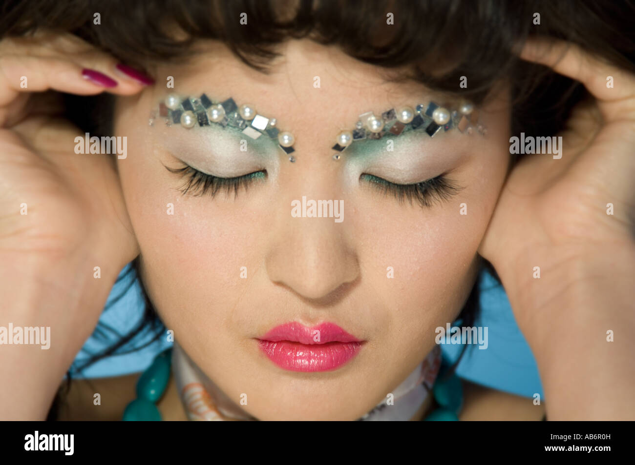 oriental woman with eyes closed Stock Photo - Alamy