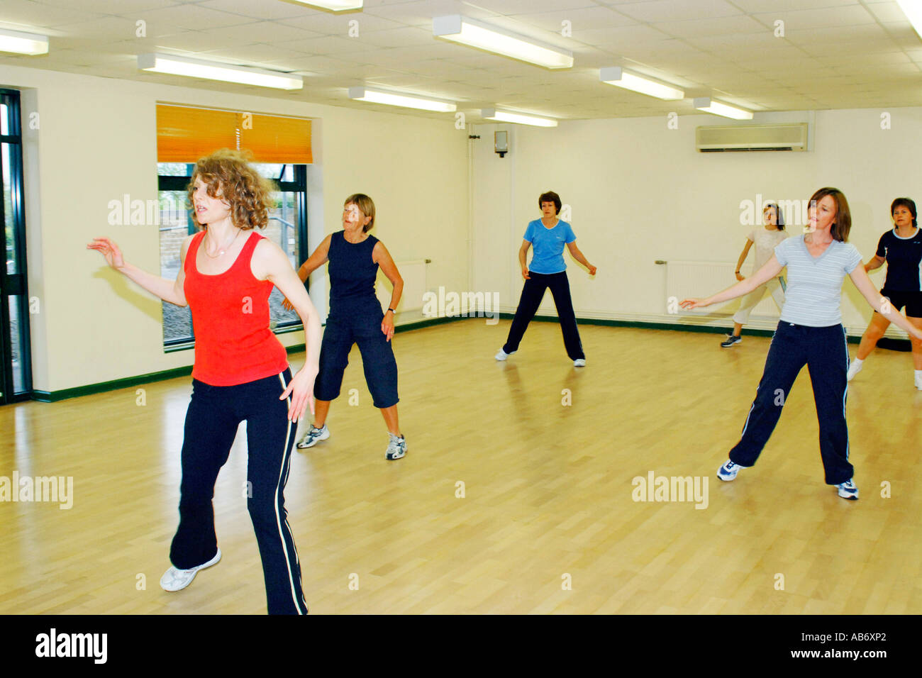 Females doing marching step exercises in a workout class Stock Photo
