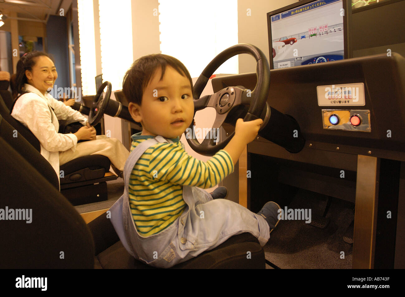 A boy driving a car simulator in Toyota s Amlux showroom in Tokyo Japan  Stock Photo - Alamy