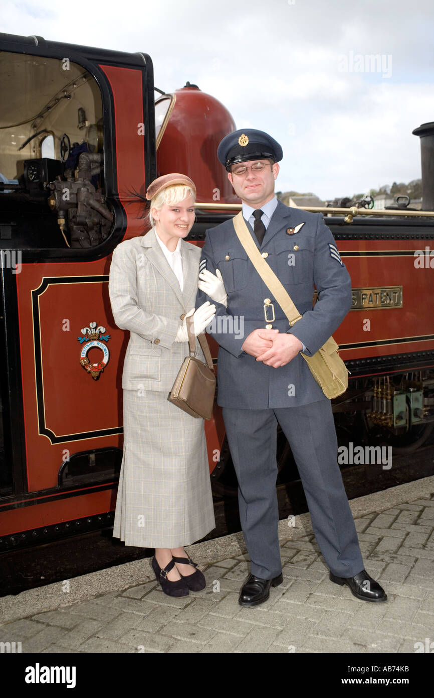 Young woman and a Royal Air Force officer in 1940's style clothing at Porthmadog Harbour station, Ffestiniog steam railway, Nort Stock Photo