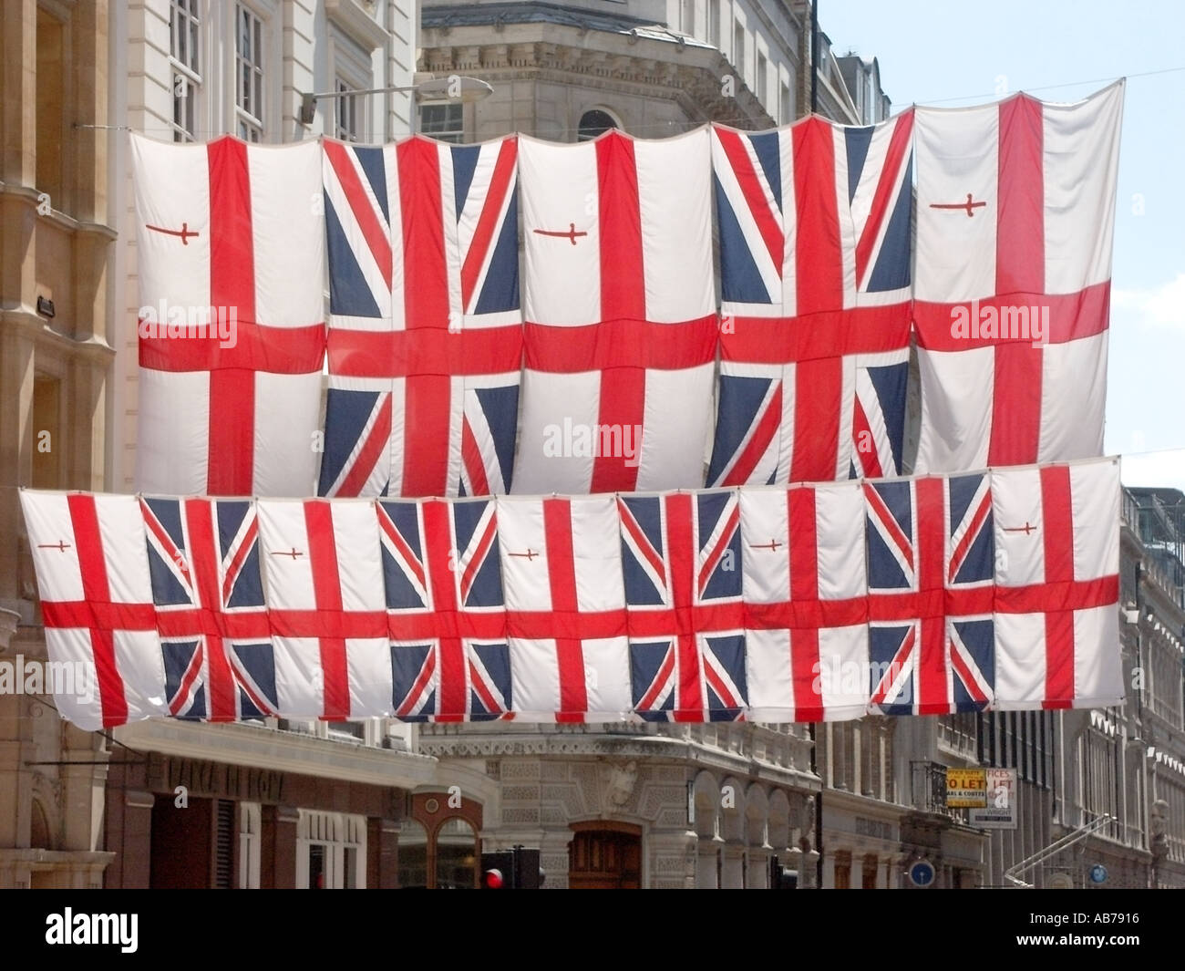 City of London close to The Guildhall Union Flags and flag of St George hung as bunting across main entrance approach road Stock Photo