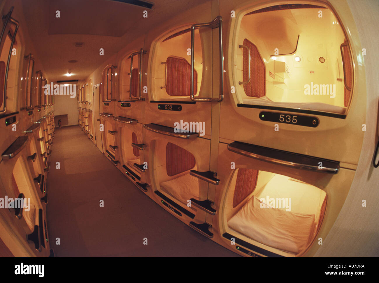 Traditional businessman's capsule hotel with small individual rooms or personal compartments in Japan Stock Photo