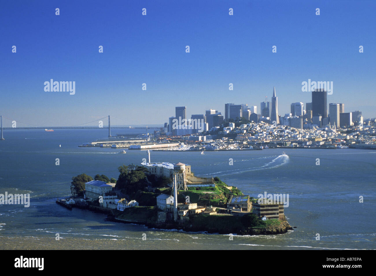Aerial view of  Alcatraz Island in San Francisco Bay with Transamerica Pyramid in city skyline and Bay Bridge Stock Photo