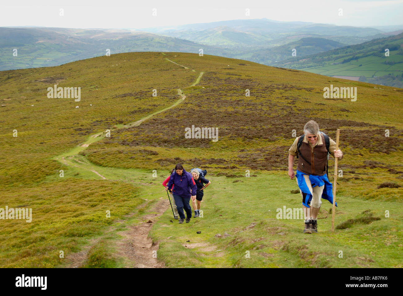 Guided walking group on footpath to Sugar Loaf mountain Abergavenny