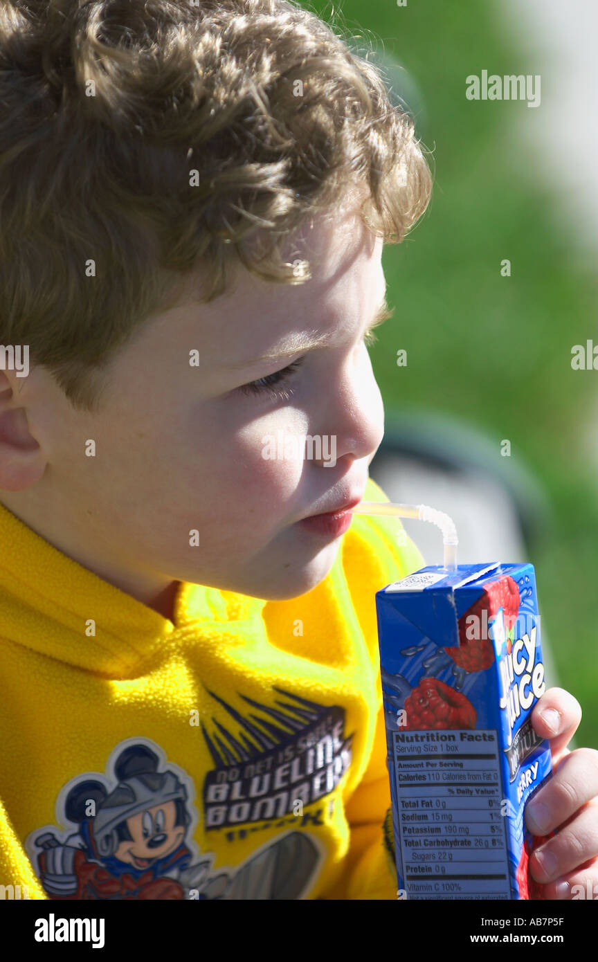 young boy drinking juice box Stock Photo Alamy