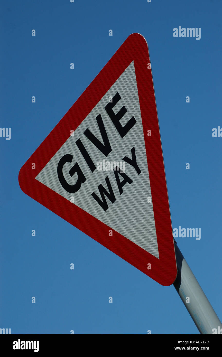 Give way road sign stop red blue Stock Photo
