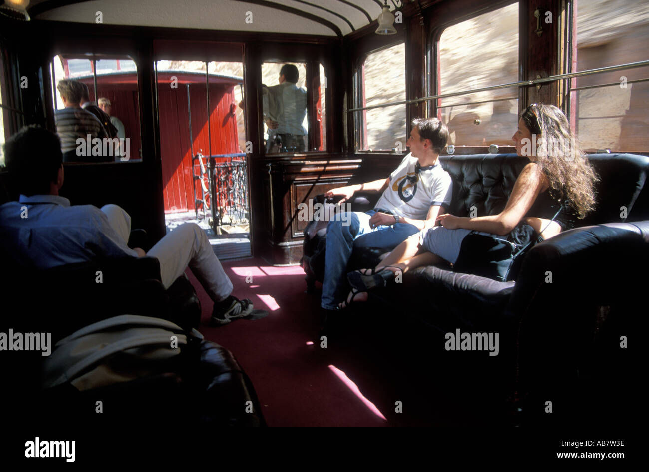 Passengers inside the Lezard Rouge train which is an old French mining train turned into a tourist train Stock Photo