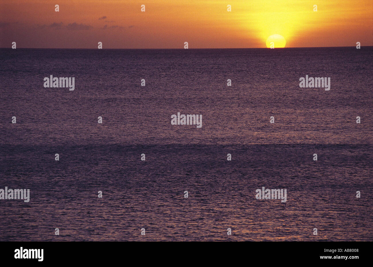 Sun setting over the sea Stock Photo