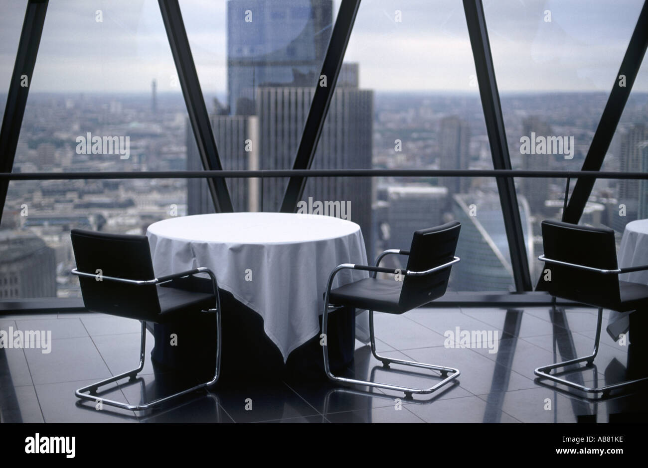 Restaurant at top of The Gherkin (AKA 30 St Mary Axe or Swiss Re Tower) with view to Tower 42 (formerly NatWest Tower), London Stock Photo
