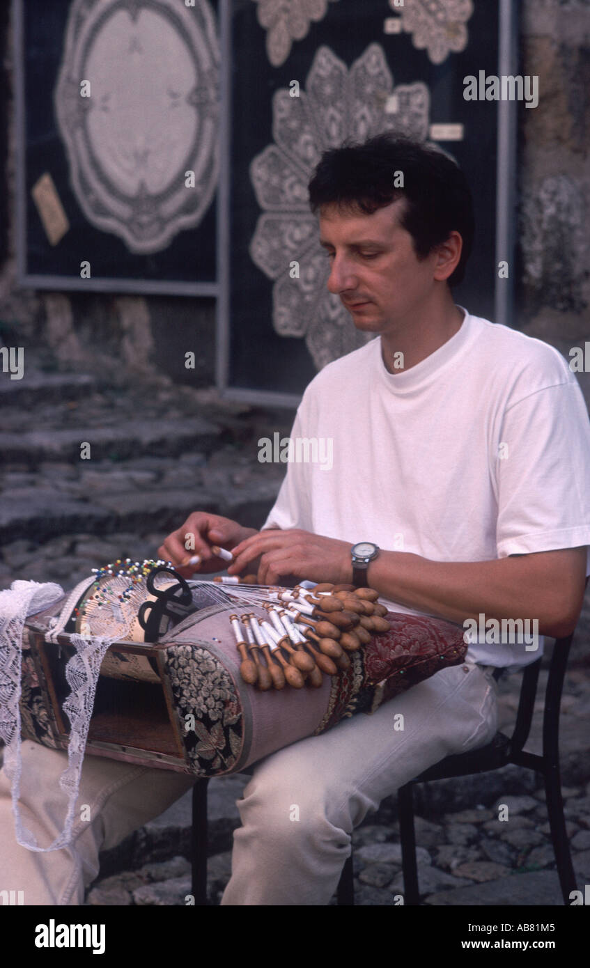 Man making traditional French lace before his shop, Le Puy-en-Velay, Haute Loire, France Stock Photo