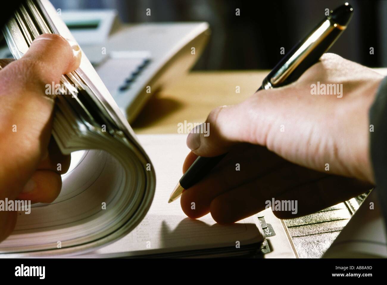 Person writing in address book Stock Photo Alamy