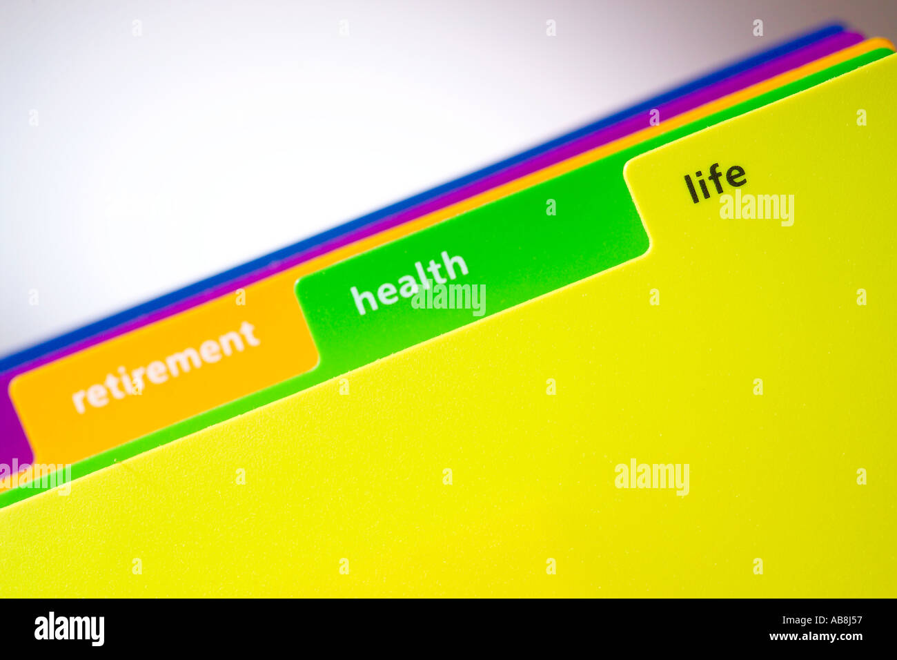 Brightly coloured plastic subject divider tabs with the word Life in focus. Stock Photo