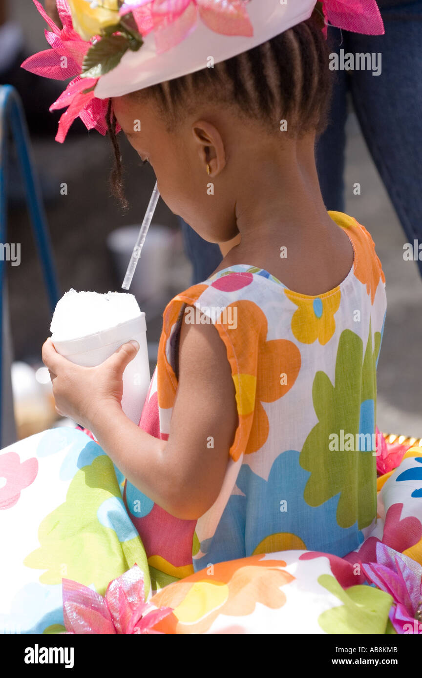 WEST INDIES TRINIDAD PORT OF SPAIN CARNIVAL 2006 Little girl enjoying a snow cone at the Kiddies Carnival Stock Photo